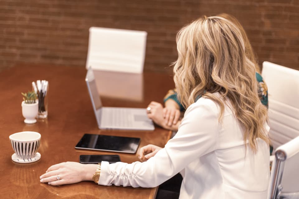 The associate working at a conference table