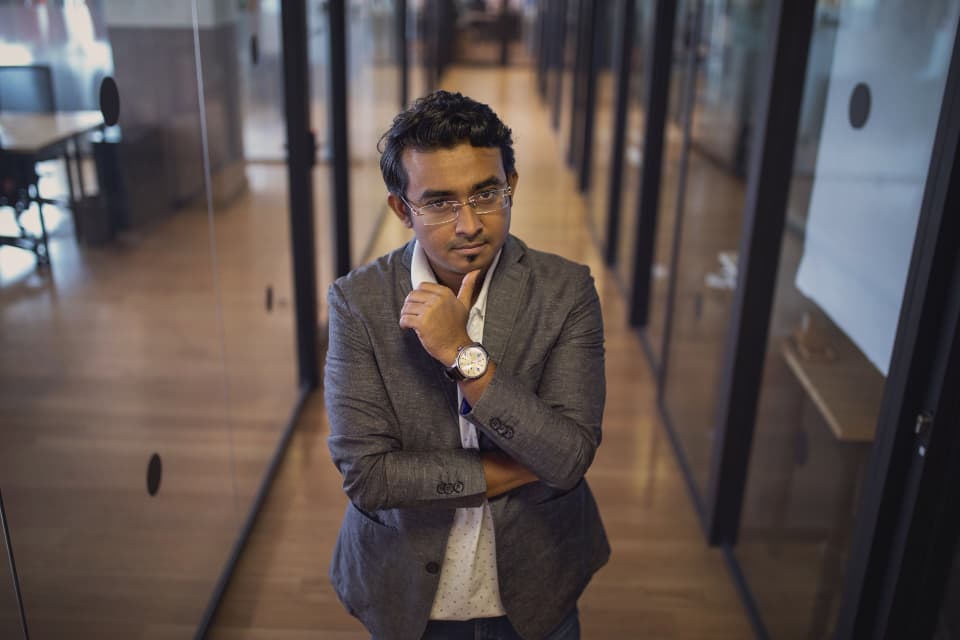 The partner standing in the office hallway